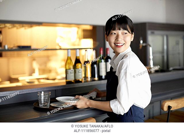 Young Japanese woman working at a restaurant