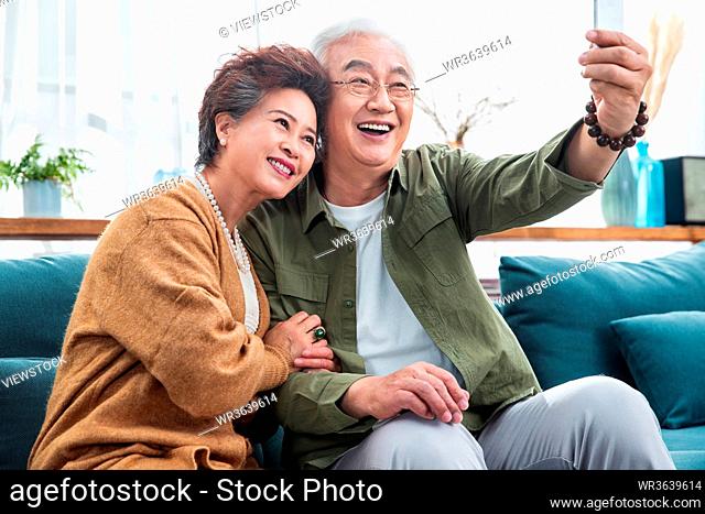 The old couple with cellphone picture of happiness