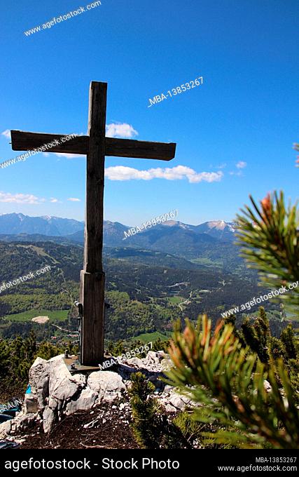 Cross on Gamseck above the Mittenwalder Hut, memorial cross in spring in front of a blue sky, woken atmosphere, atmospheric