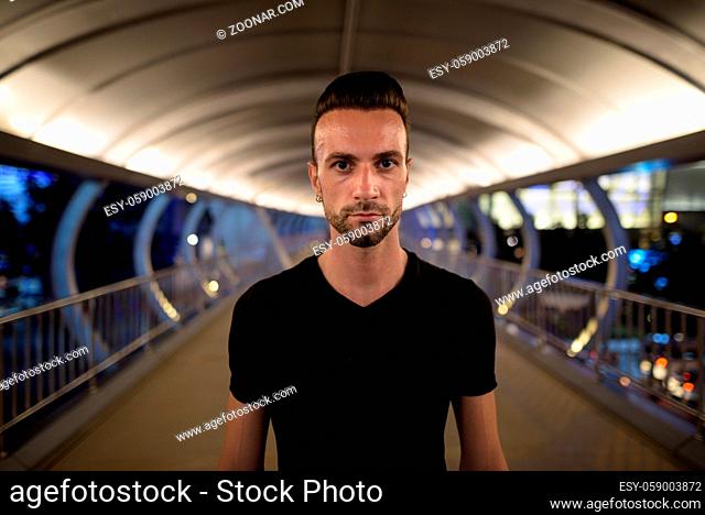 Portrait of handsome man at night shot with wide angle lens