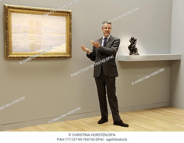 Sotheby's expert Simon Shaw stands in front of an artwork by Claude Monet (Les Glacons, Bennecourt) at Sotheby's in New York, US, 3 November 2017