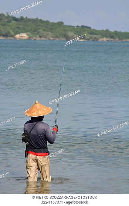 Jimbaran (Bali, Indonesia): a man fishing at the Jimbaran beach