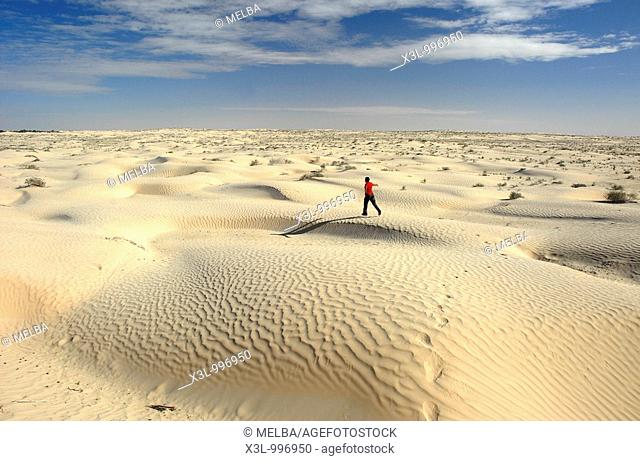 Happy man running in Douz desert  Tunisia