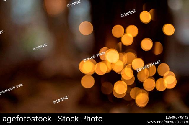 Abstract dark christmas background with blurred golden bokeh effekt and for special occasions