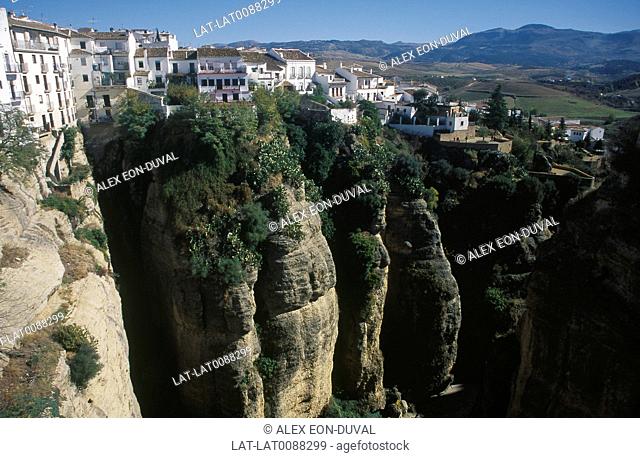 Tajo gorge, sheer cliff walls. Houses. White painted walls