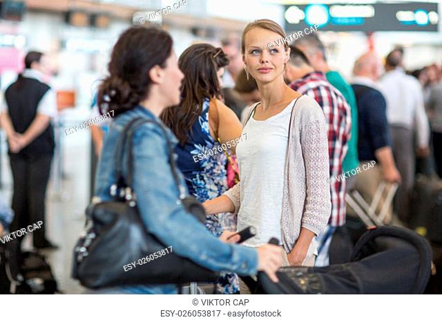 Young female passenger at the airport, about to check-in