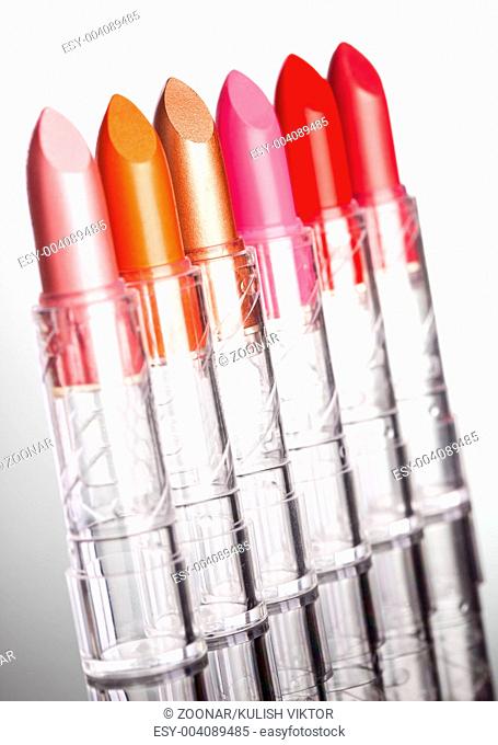 many lipsticks on white background shallow DOF
