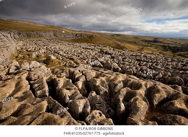 View of limestone pavement in upland landscape, above Malham Cove, Malham, Yorkshire Dales N P , North Yorkshire, England, winter