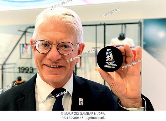 dpatop - Franz Reindl, the president of the German Ice Hockey Federaton (DEB), holds an official 2017 International Ice Hockey Federation (IIHF) World...