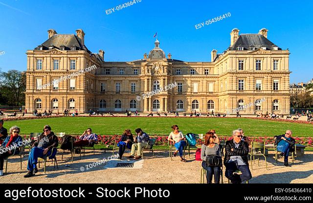 Paris, France, March 27 2017: People enjoy sunny day in the Luxembourg Garden in Paris. Luxembourg Palace is the official residence of the President of the...