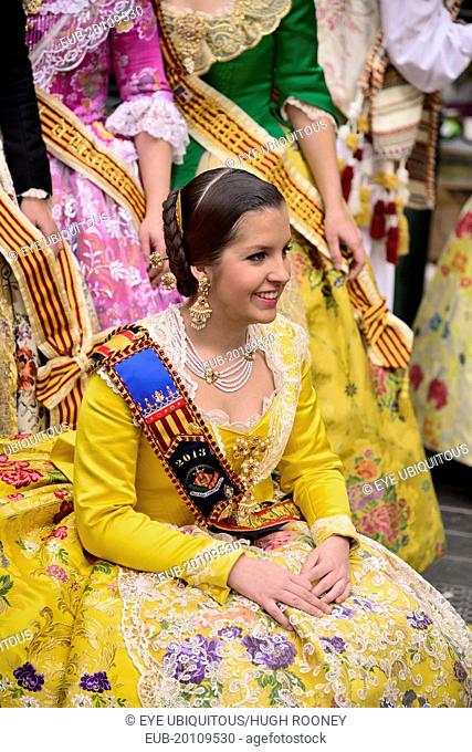 Reina Fallera in traditional Valencian costume taking a break during Las Fallas festival