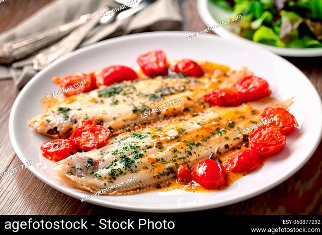 Sole with cherry tomatoes on a plate. High quality photo