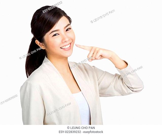 Happy woman show white teeth with finger