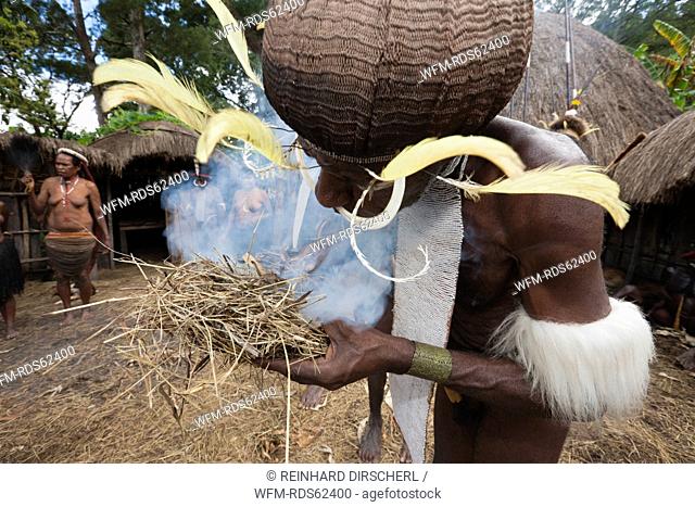 Dani Man make fire the old way, Baliem Valley, West Papua, Indonesia