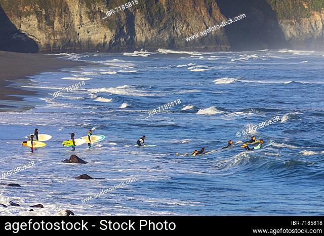 Surfers on the sandy beach Praia de Santa Barbara near Ribeira Grande, Sao Miguel Island, Azores, Portugal, Europe
