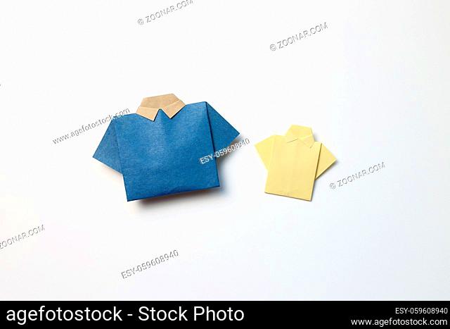 Blue and yellow paper shirt origami on white background