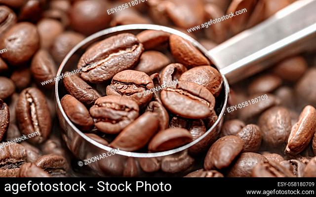 Close up of seeds of coffee. Fragrant coffee beans are roasted smoke comes from coffee beans