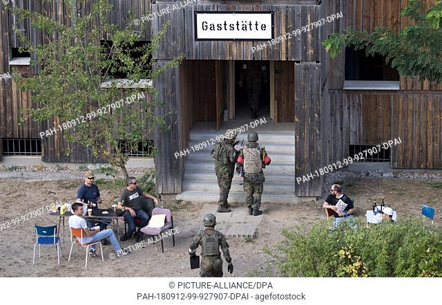 12 September 2018, Brandenburg, Brueck: During the major exercise ""Fast Vein"", soldiers of the Bundeswehr enter a fictitious restaurant on a military training...