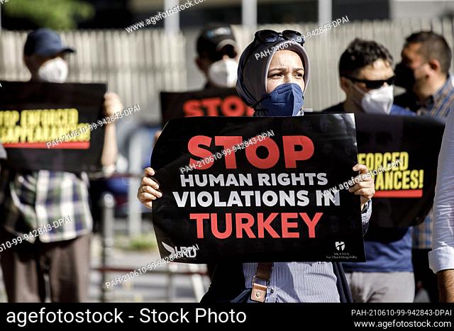 10 June 2021, Berlin: Participants of a rally demonstrate with banners in front of the Embassy of Turkey against the recent cases of so-called enforced...