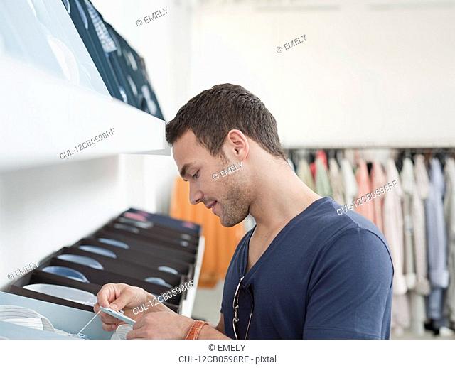man shopping looking at label