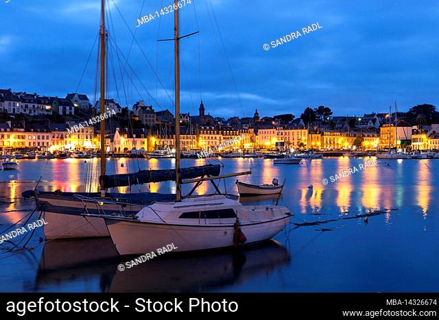 Evening atmosphere in the harbor of Audierne, residential and commercial buildings in the harbor district, France, Brittany, Département Finistère