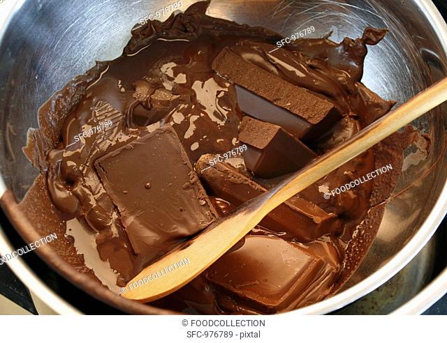 Melting chocolate couverture over bain-marie