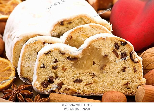 Marzipan stollen with Christmas decoration as closeup on white background