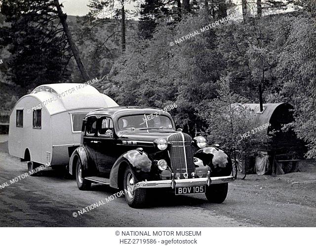 1936 Oldsmobile Eight with caravan in Scotland. Creator: Unknown