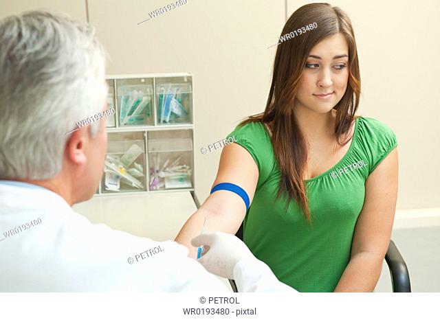 Doctor taking patient's blood sample