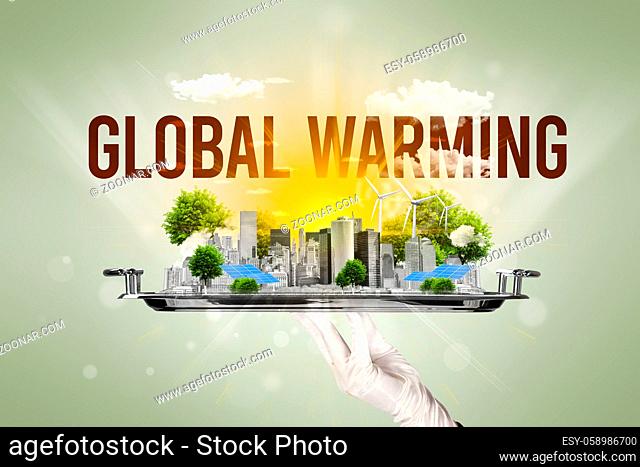 Waiter serving eco city with GLOBAL WARMING inscription, renewabke energy concept