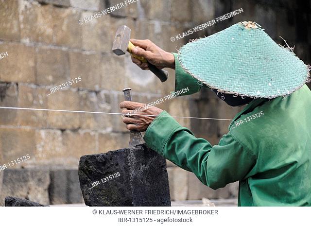 Man doing stonemasonry, restoration of the Borobudur temple, Yogyakarta, Java, Indonesia, Southeast Asia