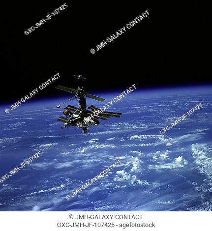 Russia's Mir Space Station, backdropped over Earth's horizon, was photographed by one of the STS-79 crew members aboard the space shuttle Atlantis as it...