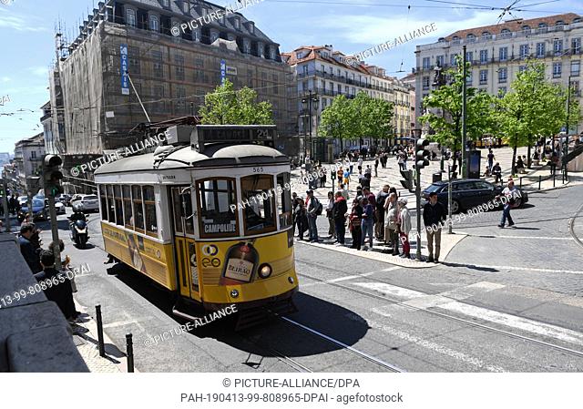 12 April 2019, Portugal, Lissabon: A tram number 24 runs through Praca Luis de Comoes. The central square in the centre of Lisbon connects the districts of...