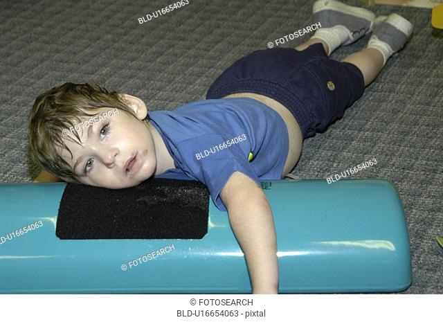 Image of a child with multiple disabilities during a physical therapy session