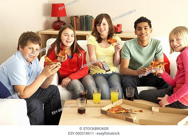Group Of Children Eating Pizza Watching TV