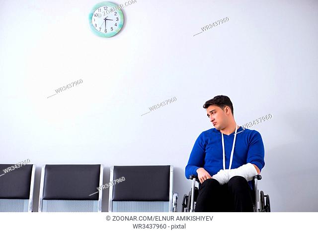 Desperate man waiting for his appointment in hospital with broken arm
