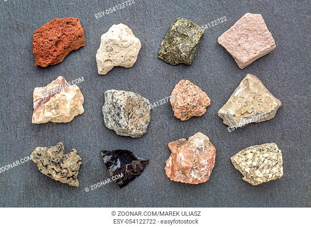 igneous rock geology collection, from top left: scoria, pumice, gabbro, tuff, rhyolite, diorite, granite, andesite, basalt, obsidian, pegmatite, porphyry