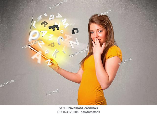 Young lady hoolding notebook with colorful abstract letters