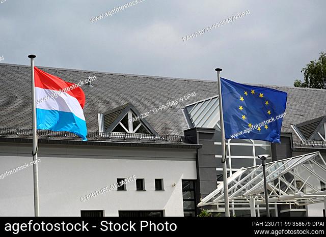 08 July 2023, Luxembourg, Marnach: The flag of the EU, European Union, Europe flag - It shows a circle of twelve golden stars on a blue background and the flag...