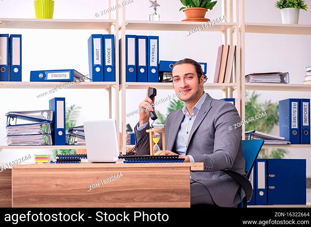 Young employee businessman at workplace