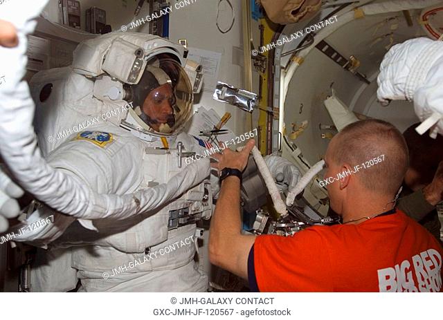 Attired in his Extravehicular Mobility Unit (EMU) spacesuit, astronaut John Danny Olivas, STS-117 mission specialist, prepares for the mission's third session...