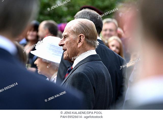 Britain's Queen Elizabeth II (L) and Prince Philip (C) at the Queen's Birthday Party at the residence of the British Ambassador to Germany in Berlin, Germany