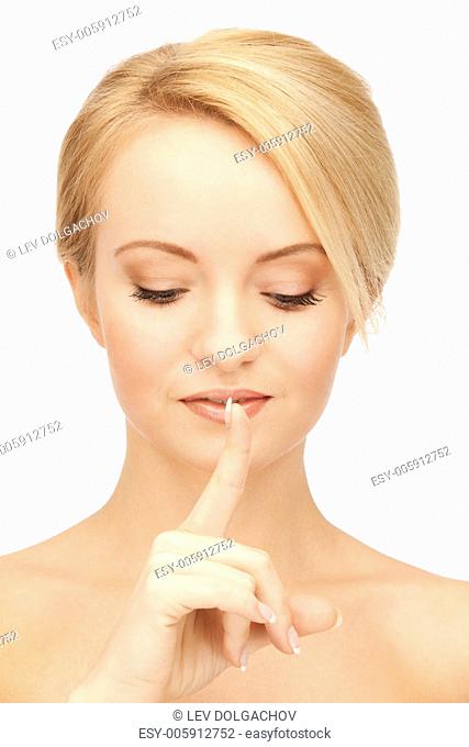 bright picture of woman with finger on lips.