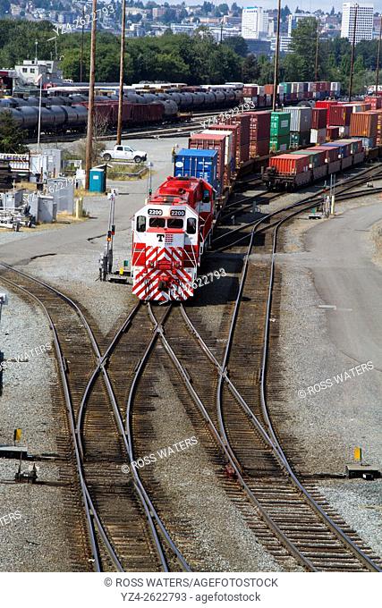 Tacoma Rail locomotives pulling a string of containers in the yard in the Port of Tacoma