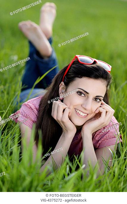 Young woman relaxing on the spring meadow - , 05/04/2014