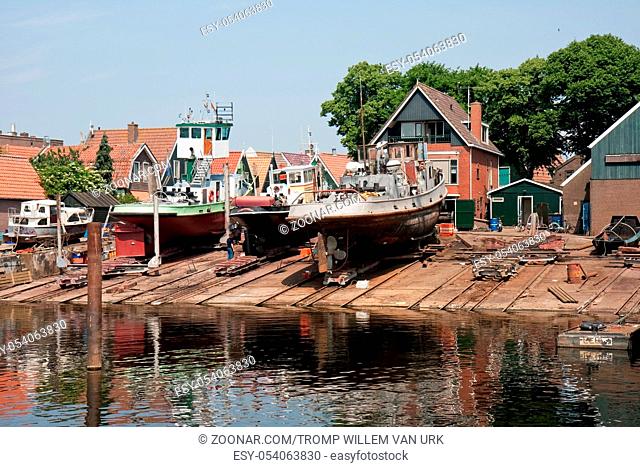 Old dutch shipyard with tugboats in fishery village urk