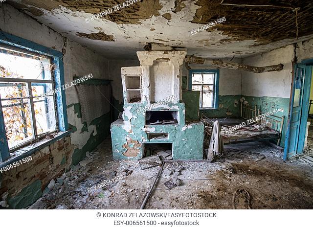 big stove in wooden cottage in small abandoned village called Stechanka, Chernobyl Nuclear Power Plant Zone of Alienation, Ukraine