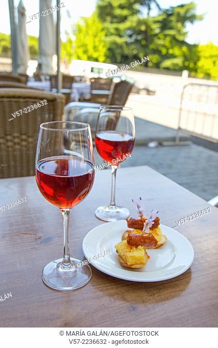 Spanish aperitif: two glasses of rose wine with tapa in a terrace. Madrid, Spain