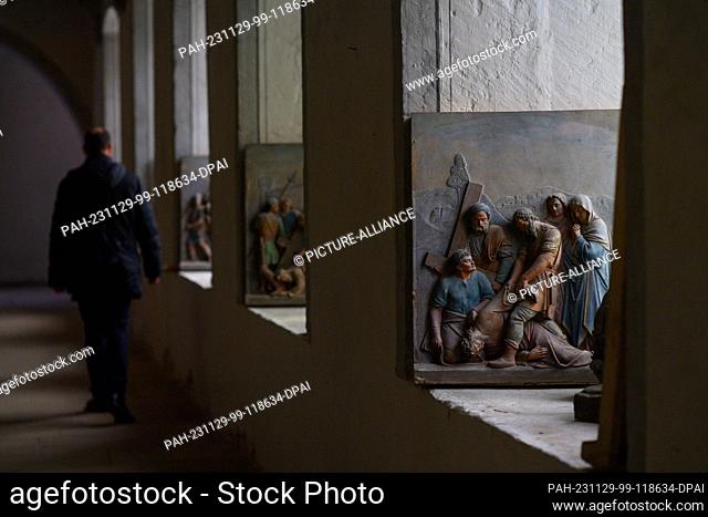 29 November 2023, Saxony-Anhalt, Hamersleben: Pictures of a Stations of the Cross are displayed in the windows of the cloister of the former Hamersleben...