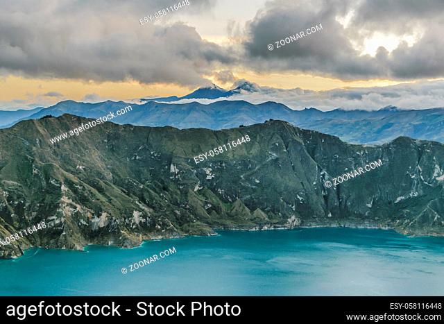 Quilotoa lake and andes range mountain against overcast cloudy background landscape scene, Ecuador